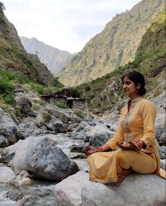 Deepshikha meditating beside a Himalayan river